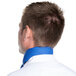 The back of a man wearing a royal blue Intedge chef neckerchief.