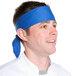 A man wearing a royal blue chef neckerchief on his head.