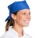 A smiling chef wearing a royal blue Intedge chef bandana.