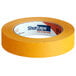 A roll of orange Shurtape general masking tape.