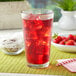 A glass of Bossen raspberry and strawberry fruit ground tea with ice and strawberries.