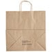 A brown paper bag with handles and black text.