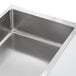 A stainless steel ServIt ice-cooled cold food table with square openings over a counter.