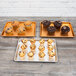 A Chicago Metallic Bakery Display Tray with blueberry, chocolate chip, and brown muffins.