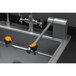 A Guardian Equipment stainless steel deck mounted eyewash station with two orange handles.