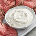 Sliced steak with a bowl of Regal Horseradish Powder on the side.