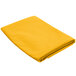 A folded yellow Intedge cloth table cover on a white background.