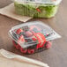 A clear plastic Choice deli container filled with fruit and salad.