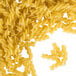 A pile of Regal rotini pasta on a white background.