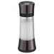 An OXO Good Grips salt mill with a glass container and a black lid.