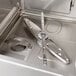 A stainless steel Hobart undercounter dishwasher with a silver handle.