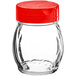 A clear glass Tablecraft shaker with a red lid.