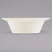 A Fineline Flairware ivory plastic bowl with a wavy design.