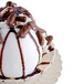 A Fineline Flairware ivory plastic bowl filled with ice cream topped with chocolate syrup.
