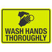 A yellow sign with black text and a hand washing symbol that says "Wash Hands Thoroughly"
