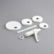 A Tablecraft condiment pump kit with white plastic pump and round adapters on a gray surface.