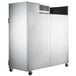 A large silver Traulsen G Series reach-in refrigerator on wheels.