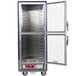 A blue metal Metro C5 heated holding cabinet with clear Dutch doors open.