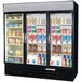 A Beverage-Air MarketMax three section glass door refrigerator with drinks and yogurt inside.