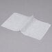 Durable Packaging interfolded deli wax paper on a gray surface.