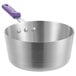 A silver saucepan with a purple silicone handle.