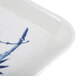 A white melamine tray with blue bamboo leaves.