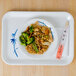 A Blue Bamboo melamine tray with a plate of food, chopsticks, and broccoli on a wood table.
