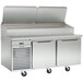A Traulsen stainless steel salad/pizza prep refrigerator with two doors on a counter.