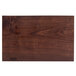 A John Boos black walnut wood cutting board with a rustic edge and company logo.