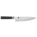 A Shun Classic chef knife with a black handle and white blade.