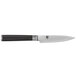 A Shun Classic paring knife with a black handle and silver blade.