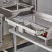 A Universal 36" Griddle Condiment Rail on a stainless steel counter.
