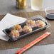 A Choice traditional rectangular plastic food container with sushi inside.