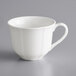 A white Acopa Condesa porcelain cup with a handle.