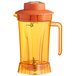An orange AvaMix blender jar with a handle.