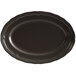 An Acopa Condesa matte black scalloped platter on a table.