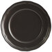 A close up of an Acopa Condesa matte black porcelain plate with a scalloped wide rim.