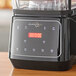 A black AvaMix Apex commercial blender with a digital display on a counter.