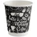 A black and white paper cup with white text that says "Coffee Break" and other words.