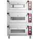 An Avantco triple deck pizza oven stacked on top of two others.