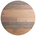 A Lancaster Table & Seating Excalibur round wooden table top with a textured farmhouse finish.