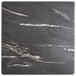 A close-up of a Lancaster Table & Seating black and white marble square table top.