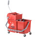 A red Unger mop bucket with a side-press wringer.