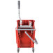 A red Unger mop bucket with a side-press wringer.