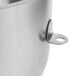 A close-up of a stainless steel KitchenAid mixing bowl with a metal handle.