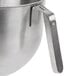 A close-up of a KitchenAid stainless steel mixing bowl with a handle.