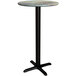 A round bar height table with a textured canyon metal top and a cross base plate.