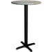 A Lancaster Table & Seating round bar height table with a black pole and textured canyon top on a cross base plate.