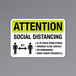 A black and yellow reflective sign that says "Attention / Social Distancing" with a symbol of people standing 6 ft apart.
