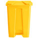 A yellow plastic Lavex step-on trash can with lid.